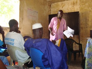 Tostan supervisor Mamadou Diarra Camara leads a discussion on social norms during the sharing seminar in Oudoucar